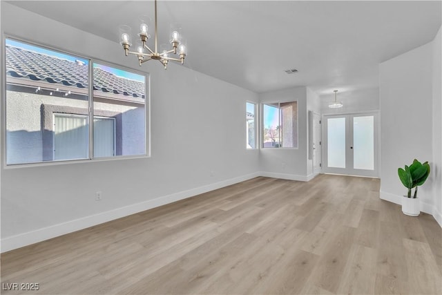 10200 Wood Work Ln, Las Vegas, NV 89135 - empty room featuring a chandelier, wood finished floors, and french doors