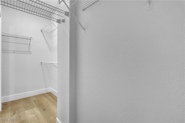 10200 Wood Work Ln, Las Vegas, NV 89135 - walk in closet featuring light wood finished floors