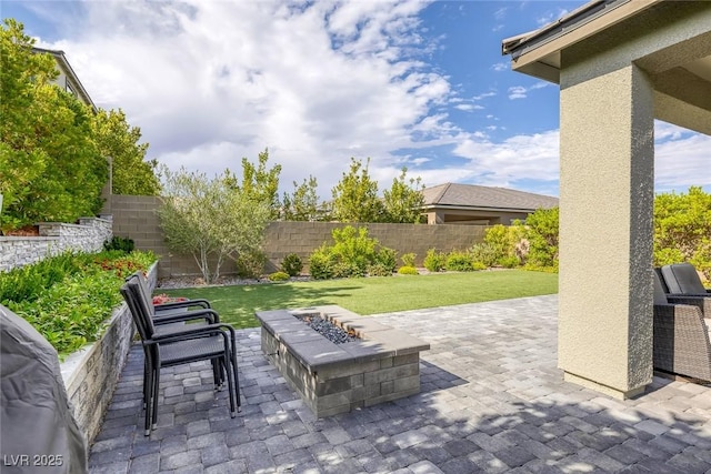 12426 Alpenglow Ct, Las Vegas, NV 89138 - fenced backyard featuring a patio and an outdoor fire pit