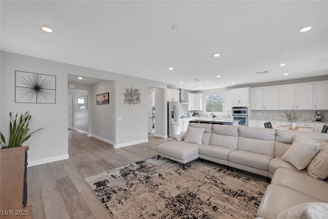 12426 Alpenglow Ct, Las Vegas, NV 89138 - living room featuring light wood finished floors and recessed lighting
