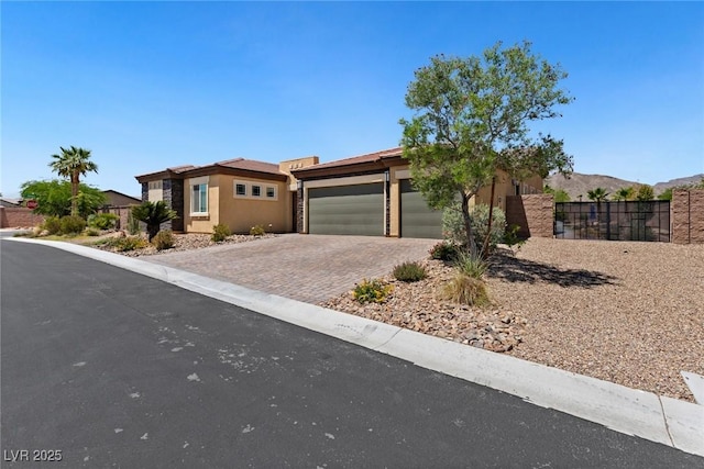 4317 Velvet Ridge Ct, Las Vegas, NV 89129 - view of front of property featuring decorative driveway, a garage, and stucco siding
