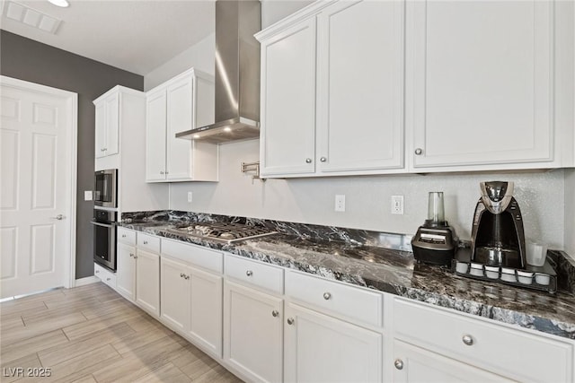 4317 Velvet Ridge Ct, Las Vegas, NV 89129 - kitchen featuring wall chimney exhaust hood, stainless steel gas stovetop, white cabinets, and dark stone countertops