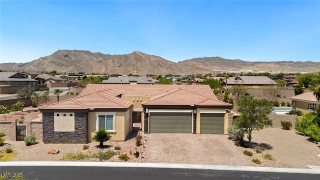 4317 Velvet Ridge Ct, Las Vegas, NV 89129 - view of front facade with stucco siding, a garage, a tile roof, driveway, and a mountain view
