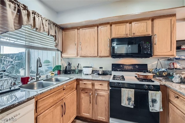 4259 Kona Coast Way, Las Vegas, NV 89121 - kitchen featuring black microwave, gas range oven, white dishwasher, and light stone counters