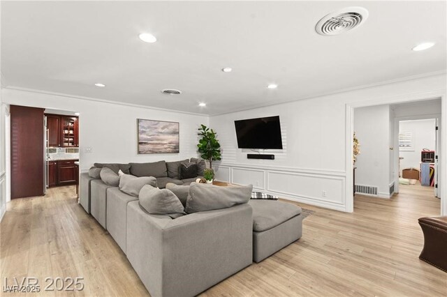 3108 Sonia Dr, Las Vegas, NV 89107 - living area with crown molding, recessed lighting, and light wood-style flooring
