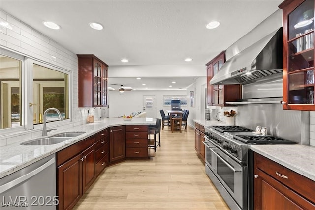 3108 Sonia Dr, Las Vegas, NV 89107 - kitchen with appliances with stainless steel finishes, light wood-type flooring, recessed lighting, decorative backsplash, and light stone countertops