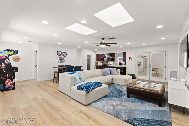 3108 Sonia Dr, Las Vegas, NV 89107 - living area featuring a skylight, recessed lighting, light wood-style flooring, french doors, and ceiling fan