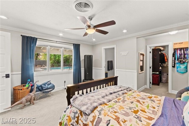 3108 Sonia Dr, Las Vegas, NV 89107 - bedroom featuring light carpet, a spacious closet, crown molding, recessed lighting, and ceiling fan