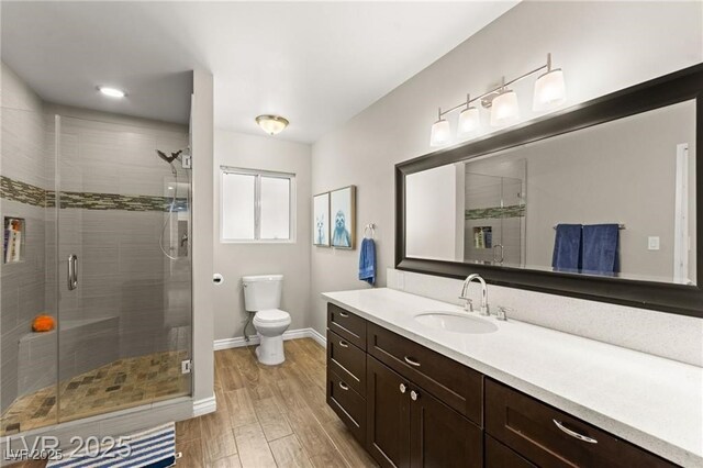 3108 Sonia Dr, Las Vegas, NV 89107 - bathroom featuring wood finished floors, vanity, and a shower stall