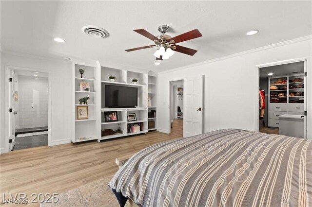 3108 Sonia Dr, Las Vegas, NV 89107 - bedroom with wood finished floors, recessed lighting, a walk in closet, ornamental molding, and ensuite bathroom