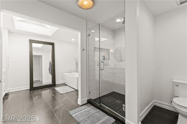 3108 Sonia Dr, Las Vegas, NV 89107 - bathroom featuring a stall shower, a freestanding bath, recessed lighting, and a skylight