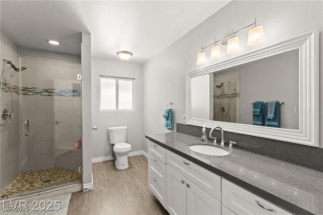 3108 Sonia Dr, Las Vegas, NV 89107 - bathroom featuring a shower stall, vanity, and wood finished floors