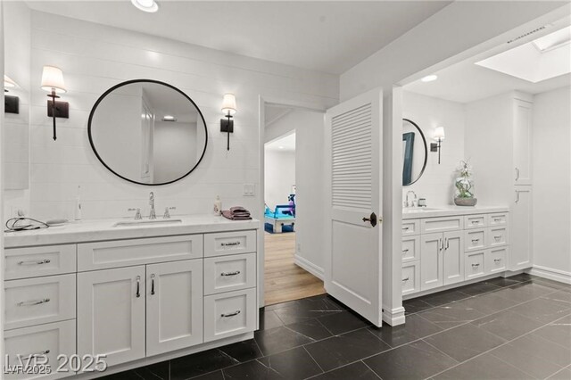 3108 Sonia Dr, Las Vegas, NV 89107 - full bath featuring two vanities, a skylight, and recessed lighting