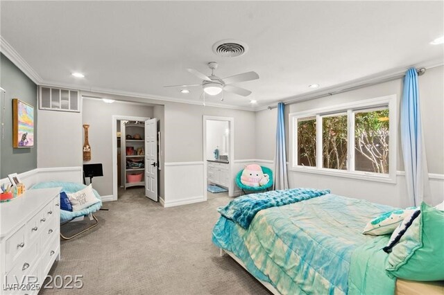 3108 Sonia Dr, Las Vegas, NV 89107 - bedroom featuring crown molding, a spacious closet, light carpet, recessed lighting, and connected bathroom