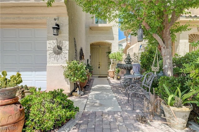 3873 Palm Island Ct, Las Vegas, NV 89147 - view of exterior entry featuring a garage and stucco siding