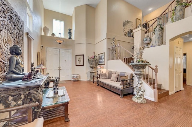 3873 Palm Island Ct, Las Vegas, NV 89147 - foyer entrance featuring a towering ceiling, stairs, arched walkways, and wood finished floors
