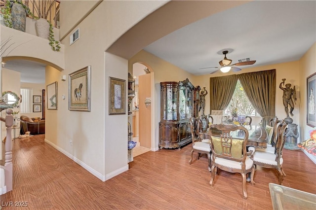 3873 Palm Island Ct, Las Vegas, NV 89147 - dining area with ceiling fan, arched walkways, and light wood finished floors