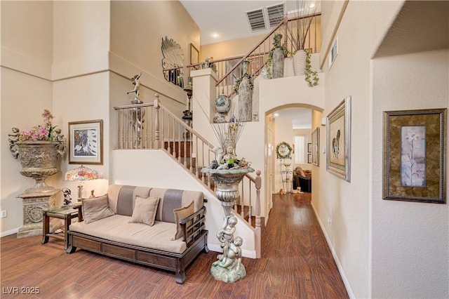 3873 Palm Island Ct, Las Vegas, NV 89147 - living room with stairway, wood finished floors, a towering ceiling, and arched walkways