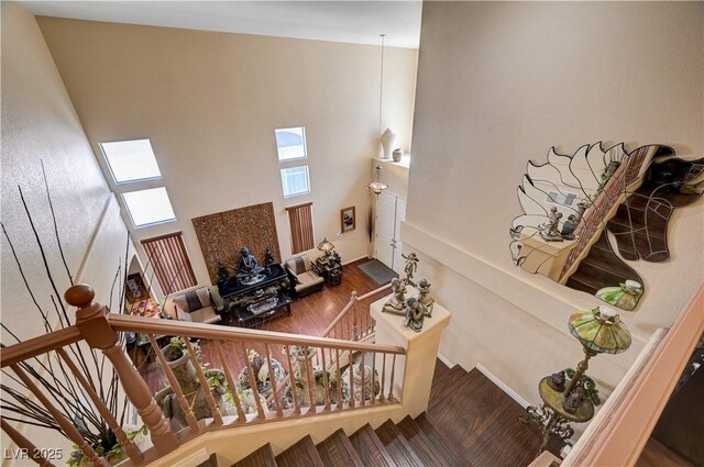 3873 Palm Island Ct, Las Vegas, NV 89147 - stairs featuring a towering ceiling, wood finished floors, and a skylight