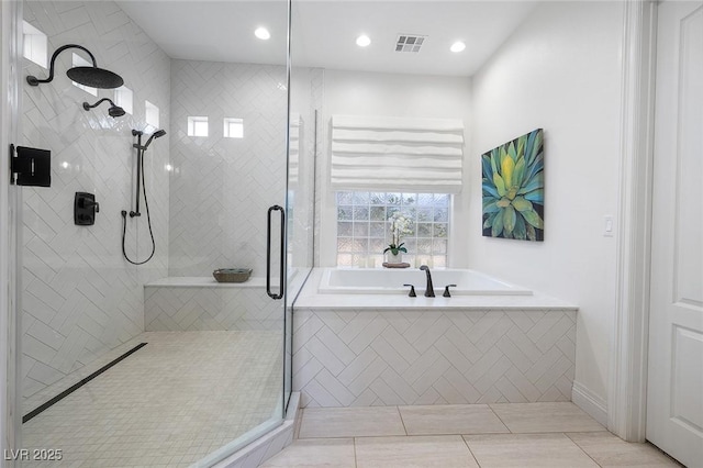 8290 Gagnier Blvd, Las Vegas, NV 89113 - full bathroom featuring a garden tub, a shower stall, tile patterned flooring, and recessed lighting