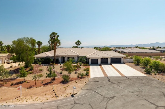 8290 Gagnier Blvd, Las Vegas, NV 89113 - ranch-style house featuring concrete driveway, a garage, and a mountain view