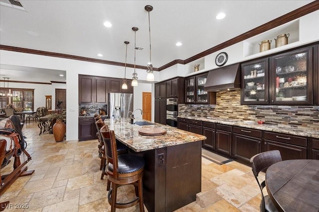 10674 Chillingham Dr, Las Vegas, NV 89183 - kitchen with appliances with stainless steel finishes, custom exhaust hood, stone tile flooring, backsplash, and recessed lighting