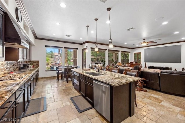 10674 Chillingham Dr, Las Vegas, NV 89183 - kitchen with stainless steel appliances, stone tile floors, crown molding, recessed lighting, and ceiling fan