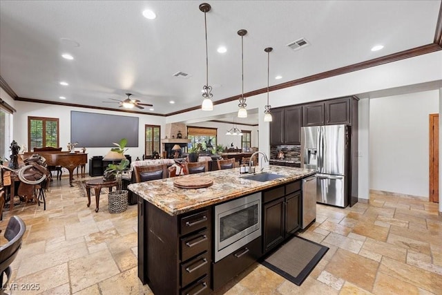 10674 Chillingham Dr, Las Vegas, NV 89183 - kitchen featuring appliances with stainless steel finishes, stone tile flooring, crown molding, light stone countertops, and decorative light fixtures
