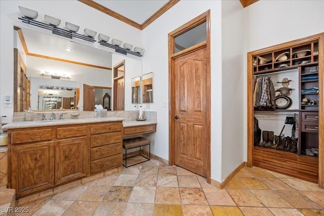 10674 Chillingham Dr, Las Vegas, NV 89183 - bathroom with ornamental molding, stone tile floors, vanity, and a spacious closet