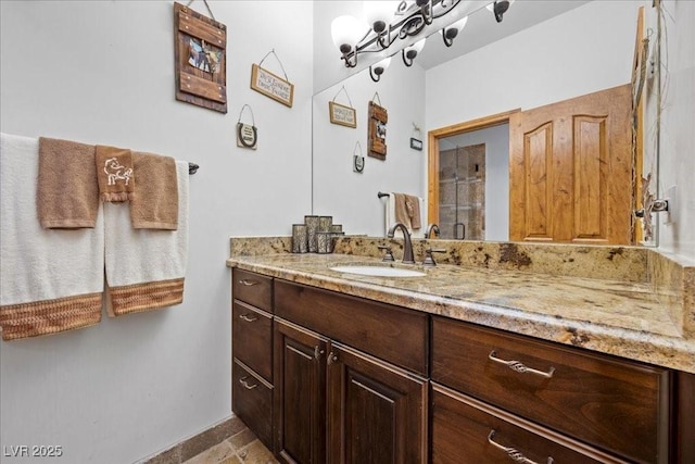 10674 Chillingham Dr, Las Vegas, NV 89183 - bathroom featuring vanity and a shower with shower door
