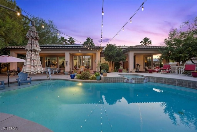 10674 Chillingham Dr, Las Vegas, NV 89183 - pool at dusk with a patio area and a pool with connected hot tub