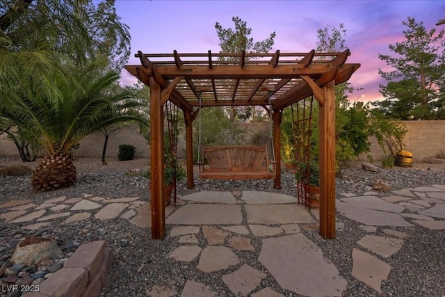 10674 Chillingham Dr, Las Vegas, NV 89183 - patio terrace at dusk featuring a fenced backyard, a patio area, and a pergola