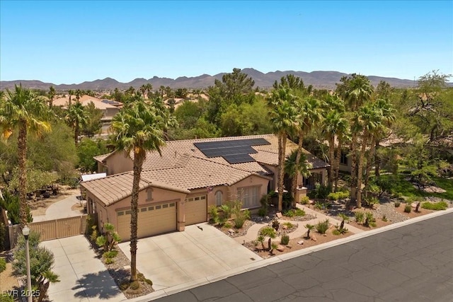 10674 Chillingham Dr, Las Vegas, NV 89183 - view of front of property with a garage, a tile roof, stucco siding, and a mountain view