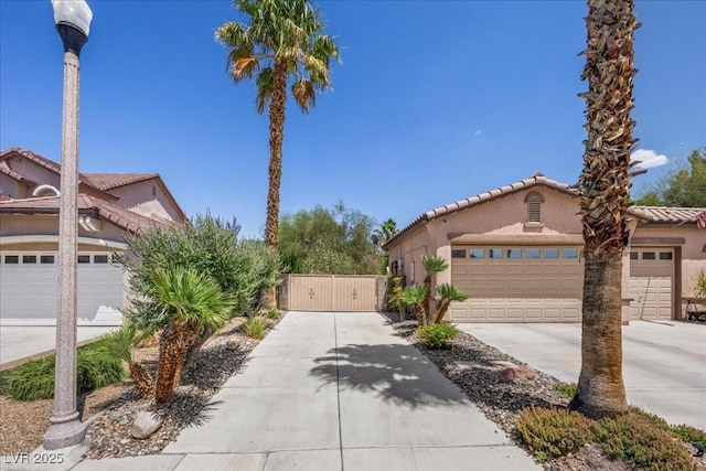 10674 Chillingham Dr, Las Vegas, NV 89183 - view of front of home with a gate, a tile roof, and stucco siding