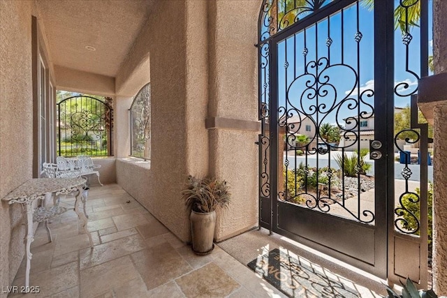 10674 Chillingham Dr, Las Vegas, NV 89183 - foyer featuring stone tile flooring, a textured wall, and a high ceiling