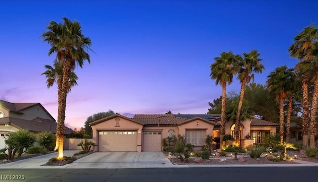10674 Chillingham Dr, Las Vegas, NV 89183 - view of front of house with a garage, stucco siding, a tiled roof, solar panels, and driveway