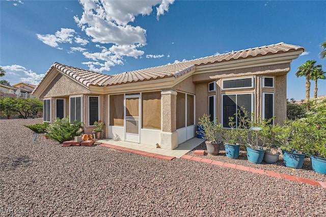 2401 Ocean Edge Ct, Las Vegas, NV 89134 - back of house with a tile roof, stucco siding, and a sunroom