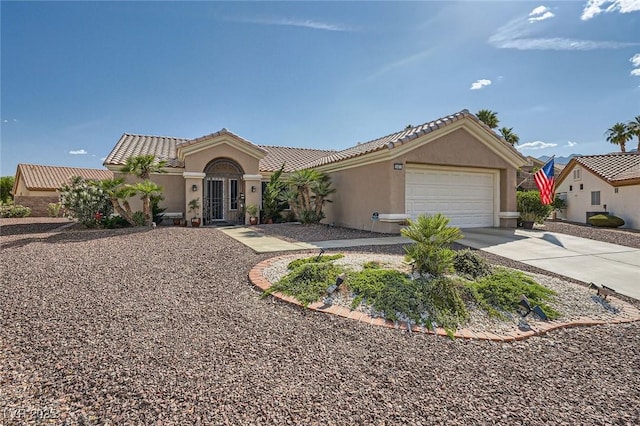 2401 Ocean Edge Ct, Las Vegas, NV 89134 - mediterranean / spanish-style home with an attached garage, concrete driveway, stucco siding, and a tile roof