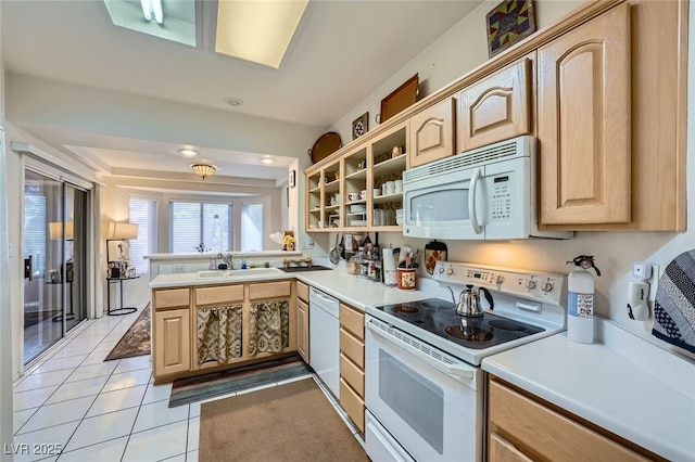 2401 Ocean Edge Ct, Las Vegas, NV 89134 - kitchen with white appliances, light brown cabinetry, light countertops, a peninsula, and light tile patterned floors