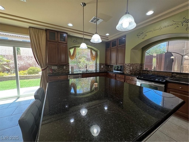 6277 Mustang Spring Ave, Las Vegas, NV 89139 - kitchen featuring appliances with stainless steel finishes, plenty of natural light, decorative backsplash, crown molding, and recessed lighting