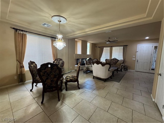 6277 Mustang Spring Ave, Las Vegas, NV 89139 - dining space with a raised ceiling, light tile patterned floors, a chandelier, and ceiling fan