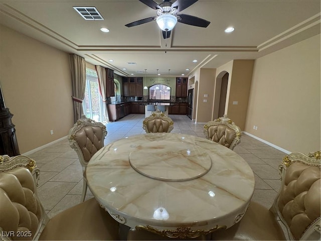 6277 Mustang Spring Ave, Las Vegas, NV 89139 - dining area with arched walkways, light tile patterned floors, a ceiling fan, recessed lighting, and a tray ceiling