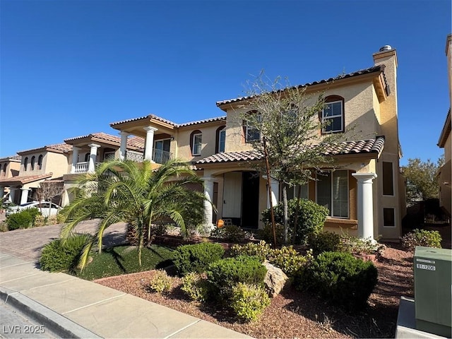 6277 Mustang Spring Ave, Las Vegas, NV 89139 - mediterranean / spanish-style house with a tile roof, stucco siding, and a chimney