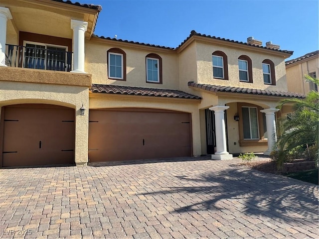 6277 Mustang Spring Ave, Las Vegas, NV 89139 - view of front of house featuring a garage, stucco siding, and decorative driveway