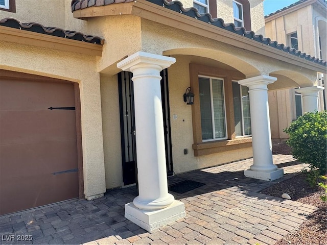 6277 Mustang Spring Ave, Las Vegas, NV 89139 - view of exterior entry featuring stucco siding, a tiled roof, and a porch