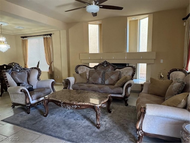 6277 Mustang Spring Ave, Las Vegas, NV 89139 - tiled living room featuring a ceiling fan and a chandelier