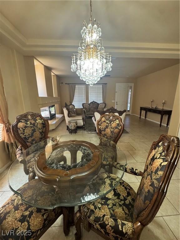 6277 Mustang Spring Ave, Las Vegas, NV 89139 - dining area featuring a chandelier, a tray ceiling, and light tile patterned floors