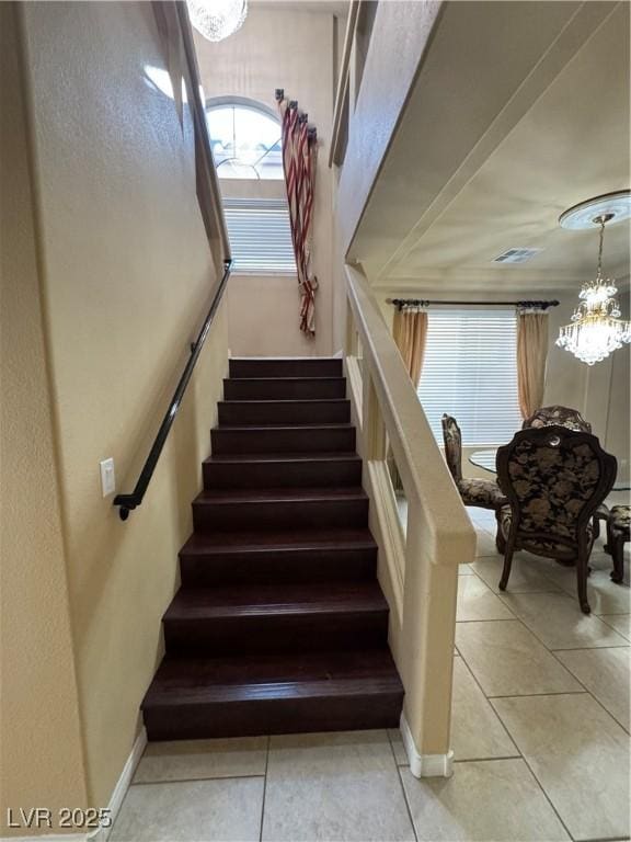 6277 Mustang Spring Ave, Las Vegas, NV 89139 - stairs featuring a chandelier and tile patterned flooring