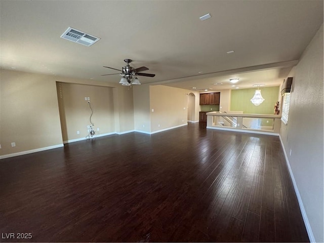 6277 Mustang Spring Ave, Las Vegas, NV 89139 - unfurnished living room featuring a ceiling fan, dark wood finished floors, and arched walkways