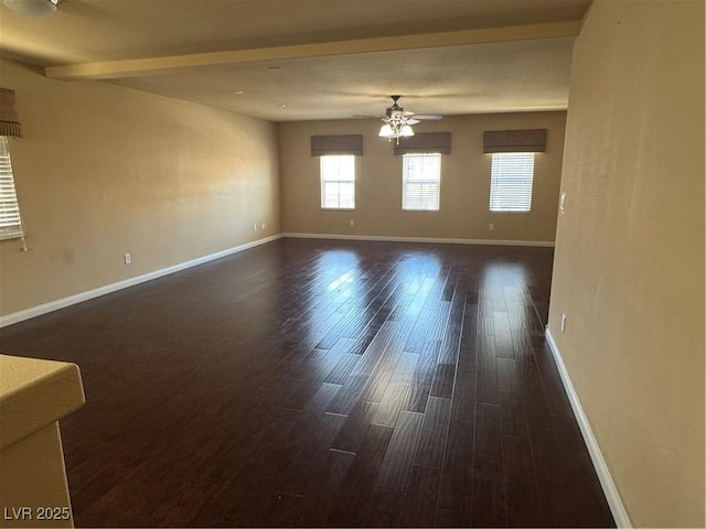 6277 Mustang Spring Ave, Las Vegas, NV 89139 - unfurnished room with ceiling fan, dark wood-style floors, and beamed ceiling